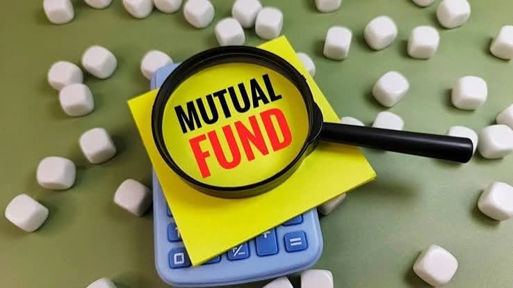 Magnifying glass highlighting a mutual fund note on a calculator
